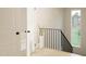 Bright staircase with modern black railing and large window for natural light illuminating the way at 3612 Bailey Meadows Drive Dr, Wake Forest, NC 27587