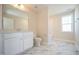 Bathroom featuring a large mirror, white cabinetry, toilet, and combined shower-tub at 335 Tobacco Barn Dr, Angier, NC 27501