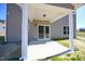 Covered back patio features neutral paint and a sliding glass door at 335 Tobacco Barn Dr, Angier, NC 27501