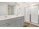 Bathroom with double vanity, large mirror and a glass shower at 3604 Drafton Dr, Raleigh, NC 27610