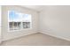Bright bedroom featuring a large window with natural light and neutral carpeting at 3604 Drafton Dr, Raleigh, NC 27610
