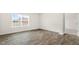 A bright bedroom featuring hardwood floors and a window with blinds at 3604 Drafton Dr, Raleigh, NC 27610