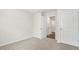Neutral carpeted bedroom featuring light walls and multiple doors at 3604 Drafton Dr, Raleigh, NC 27610