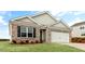 Classic single-Gathering home with brick and neutral siding, complemented by a well-manicured lawn and two-car garage at 3604 Drafton Dr, Raleigh, NC 27610