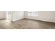 Spacious room with wood-look flooring, natural light and a sliding door leading outdoors at 3604 Drafton Dr, Raleigh, NC 27610