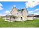 Tan house with covered patio and grassy yard at 51 Blackberry Ln, Benson, NC 27504