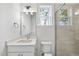 Bathroom featuring modern vanity, glass enclosed shower, and a window at 2506 Silas Peak Ln, Apex, NC 27523