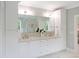 This is a bathroom with double sinks and white cabinets and a large mirror at 2506 Silas Peak Ln, Apex, NC 27523