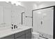 Modern bathroom featuring a black framed shower, sleek vanity, and stylish geometric floor tiles at 2506 Silas Peak Ln, Apex, NC 27523