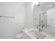 Modern bathroom features white cabinetry, a large mirror, and a tiled shower at 2506 Silas Peak Ln, Apex, NC 27523