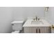 A modern bathroom featuring a white vanity with marble countertop and gold fixtures at 2506 Silas Peak Ln, Apex, NC 27523