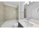 Modern bathroom featuring a shower over the tub, a white vanity, and a large mirror at 2506 Silas Peak Ln, Apex, NC 27523