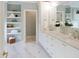 This is a bathroom with double sinks and white cabinets with marble countertop at 2506 Silas Peak Ln, Apex, NC 27523
