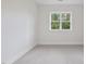 Bright bedroom with carpet floors and a large window with a view of the surrounding landscape at 2506 Silas Peak Ln, Apex, NC 27523