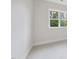 Bright bedroom with carpet floors and a large window with a view of the surrounding landscape at 2506 Silas Peak Ln, Apex, NC 27523