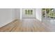 Bright bedroom with wood floors and a large window with a view of the surrounding landscape at 2506 Silas Peak Ln, Apex, NC 27523