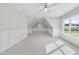 An airy bedroom featuring a ceiling fan, carpet, wainscoting, and natural light at 2506 Silas Peak Ln, Apex, NC 27523