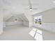 Bright bedroom features carpet, wainscoting, a ceiling fan, and two windows at 2506 Silas Peak Ln, Apex, NC 27523