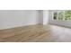 Bright bedroom with wood floors and a large window with a view of the surrounding landscape at 2506 Silas Peak Ln, Apex, NC 27523