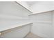 Walk-in closet with custom shelving and ample storage space for clothing and accessories at 2506 Silas Peak Ln, Apex, NC 27523