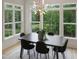 Bright dining room featuring large windows with nature views and a decorative light fixture at 2506 Silas Peak Ln, Apex, NC 27523
