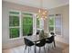 Dining room features large windows overlooking mature trees and modern light fixture at 2506 Silas Peak Ln, Apex, NC 27523