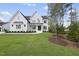 Beautifully landscaped, two-story home with a painted brick facade, black trim, and a manicured lawn at 2506 Silas Peak Ln, Apex, NC 27523