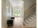 Bright foyer with staircase, wood floors, and modern lighting fixture offers a warm welcome at 2506 Silas Peak Ln, Apex, NC 27523