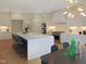 Spacious white kitchen featuring a large central island with seating and modern appliances at 2506 Silas Peak Ln, Apex, NC 27523