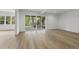 Bright living room with wood floors, recessed lighting and sliding glass doors leading to the outdoors at 2506 Silas Peak Ln, Apex, NC 27523
