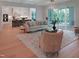 Spacious living room open to the kitchen with wood floors, fireplace, and screened porch access at 2506 Silas Peak Ln, Apex, NC 27523