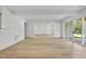 Bright living room with wood floors, recessed lighting and sliding glass doors leading to the outdoors at 2506 Silas Peak Ln, Apex, NC 27523
