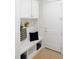 This mudroom has custom white cabinets and a bench with storage and a door at 2506 Silas Peak Ln, Apex, NC 27523