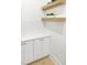 Pantry featuring white cabinets, white subway tile backsplash, and wooden floating shelves at 2506 Silas Peak Ln, Apex, NC 27523