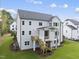 Stunning rear exterior showing the deck and patio with well manicured lawn at 2506 Silas Peak Ln, Apex, NC 27523