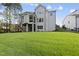 Expansive backyard with lush green grass and mature trees, perfect for outdoor activities at 2506 Silas Peak Ln, Apex, NC 27523