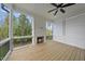 Inviting screened porch boasts a cozy fireplace, ceiling fan, and serene outdoor views at 2506 Silas Peak Ln, Apex, NC 27523