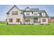 Charming two-story home featuring a brick facade, symmetrical design, and warm wooden shutters at 2590 Lassiter Rd, Four Oaks, NC 27524