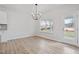 Bright dining area with hardwood floors, a modern chandelier, and large windows showcasing the outdoor space at 124 August Pond Way # 138, Raleigh, NC 27603