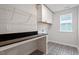 Laundry room featuring a black counter, patterned floors, and storage at 124 August Pond Way # 138, Raleigh, NC 27603