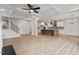 Open-concept living room with wood floors, a coffered ceiling, and an adjacent modern kitchen at 124 August Pond Way # 138, Raleigh, NC 27603
