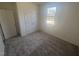 Bright bedroom with carpet flooring, double door closet, and a window with natural light at 1111 Woody Dr, Graham, NC 27253