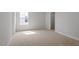 Sunlit bedroom with a large window and neutral carpeting, creating a serene atmosphere at 134 Black Walnut Dr # 205, Garner, NC 27529