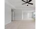 A spacious bedroom with carpeted floors and a fan; doorways lead to the other rooms in the home at 134 Black Walnut Dr # 205, Garner, NC 27529