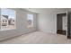Bright bedroom with carpet flooring and natural light from two windows at 134 Black Walnut Dr # 205, Garner, NC 27529