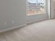 Bedroom featuring carpet flooring and a large window with neighborhood views at 134 Black Walnut Dr # 205, Garner, NC 27529