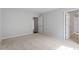 Bright bedroom featuring neutral paint, plush carpeting, and doorways leading to other spaces at 134 Black Walnut Dr # 205, Garner, NC 27529