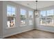 Dining room features large windows providing natural light with modern chandelier at 134 Black Walnut Dr # 205, Garner, NC 27529