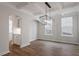 Open-concept dining room with modern chandelier at 134 Black Walnut Dr # 205, Garner, NC 27529
