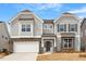 Beautiful two-story home with gray siding, stone accents, and a two-car garage at 134 Black Walnut Dr # 205, Garner, NC 27529